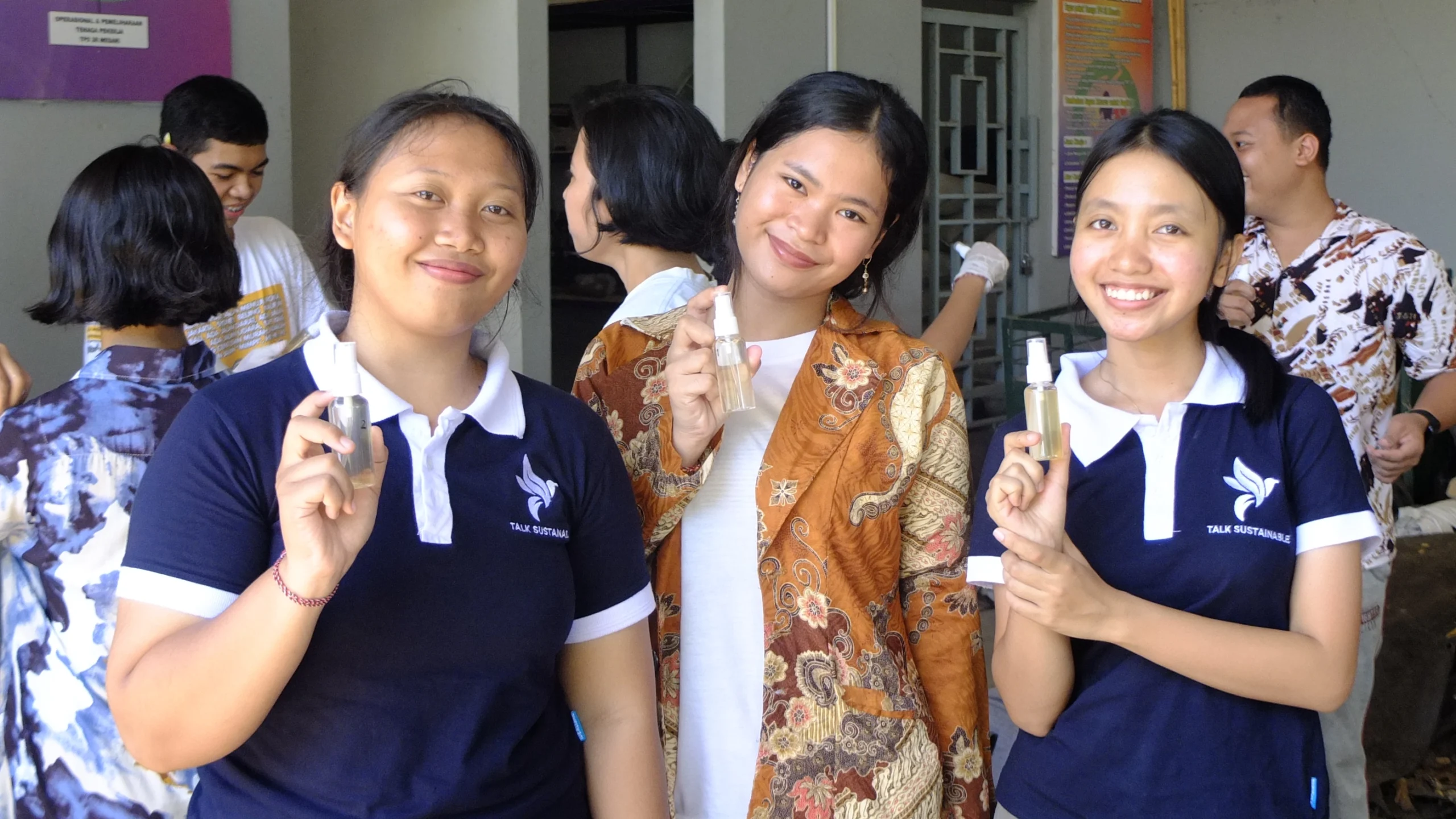 participants hold hand sanitizer from eco enzyme